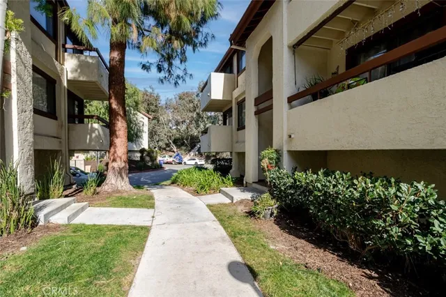 a view of a pathway both side of the house