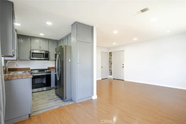 a large kitchen with a refrigerator and a stove top oven