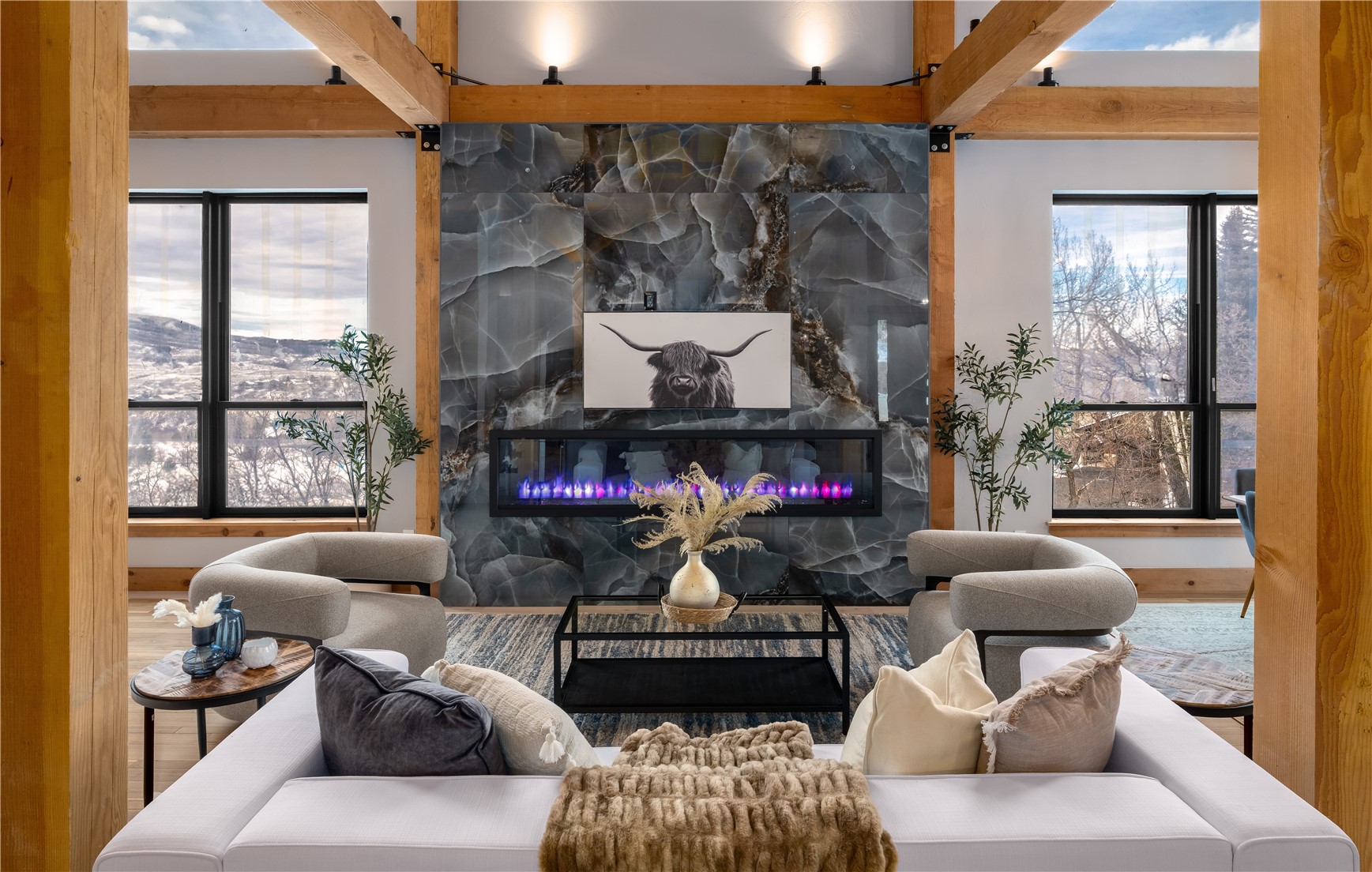 200 Sundance Court, Unit 1 Steamboat Springs, CO 80487 - Photo 11 of 50 Living area featuring a fireplace, wood finished floors, healthy amount of natural light, and beamed ceiling