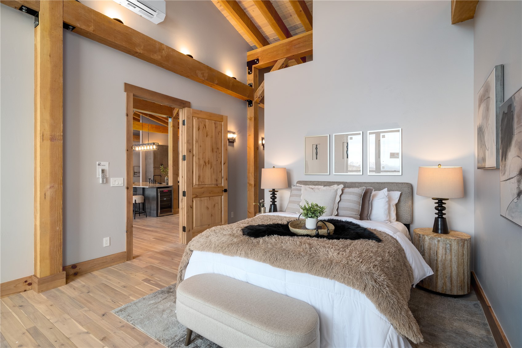 200 Sundance Court, Unit 1 Steamboat Springs, CO 80487 - Photo 20 of 50 Bedroom with wood finished floors, an AC wall unit, beamed ceiling, wine cooler, and high vaulted ceiling