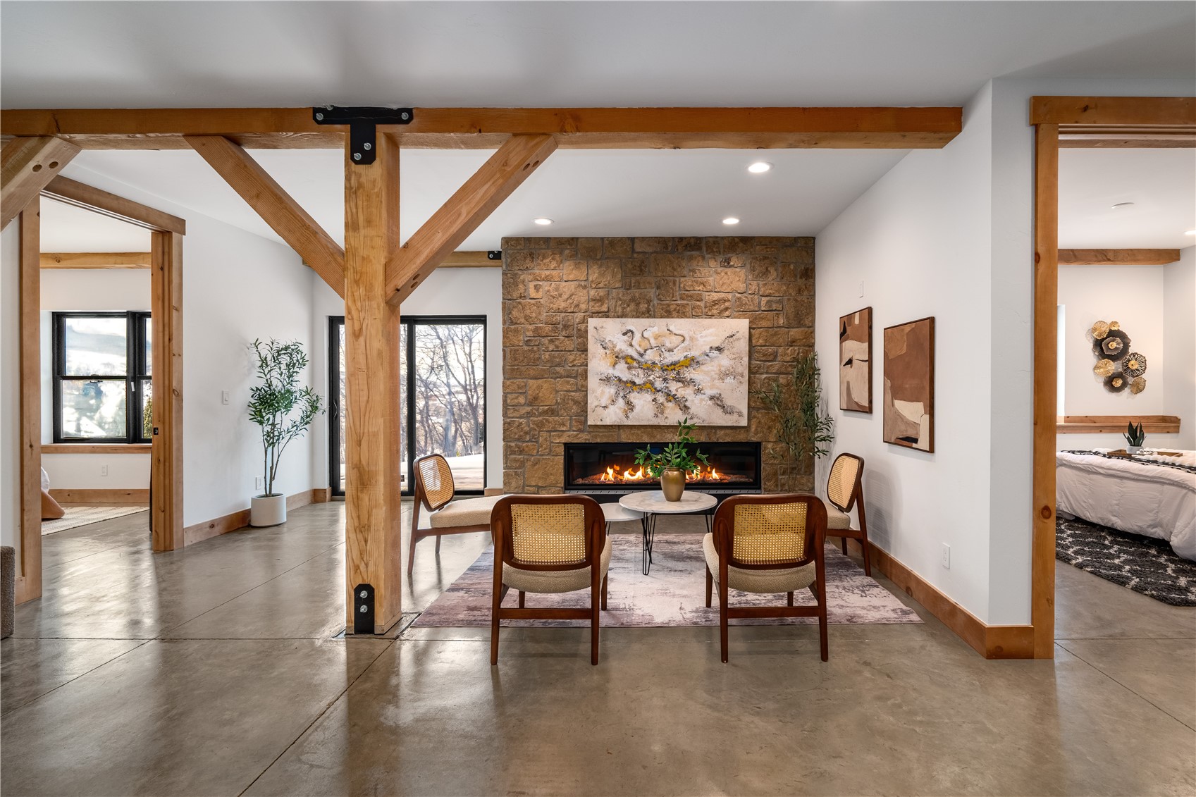 200 Sundance Court, Unit 1 Steamboat Springs, CO 80487 - Photo 24 of 50 Dining area featuring finished concrete floors, beamed ceiling, a large fireplace, and recessed lighting