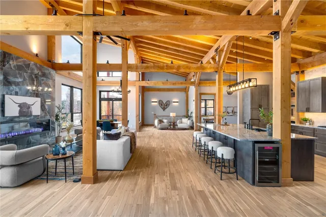 a living room with couches a barbecue dining table and chairs with wooden floor