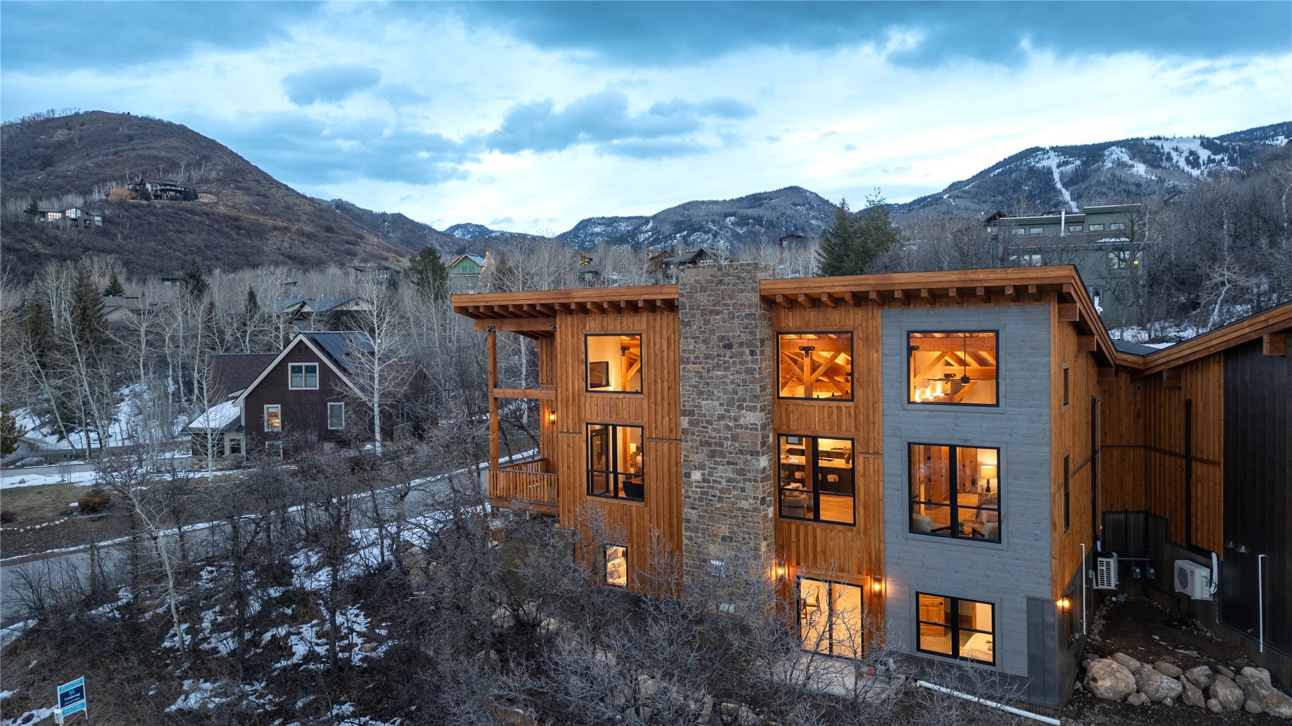 200 Sundance Court, Unit 1 Steamboat Springs, CO 80487 - Photo 42 of 50 Snow covered back of property with a mountain view, a balcony, and a chimney
