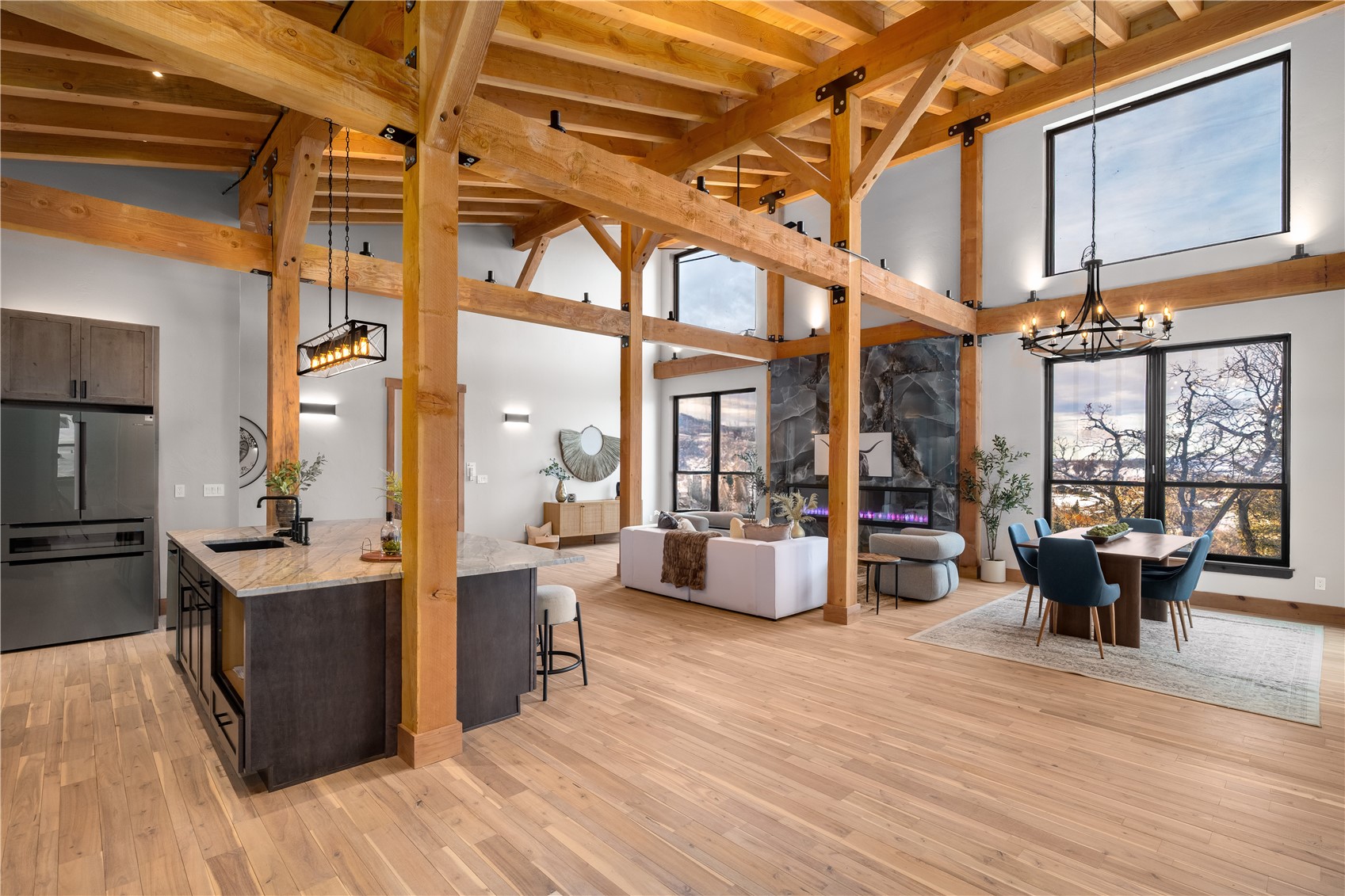 200 Sundance Court, Unit 1 Steamboat Springs, CO 80487 - Photo 5 of 50 Kitchen featuring decorative light fixtures, a chandelier, freestanding refrigerator, open floor plan, and a breakfast bar