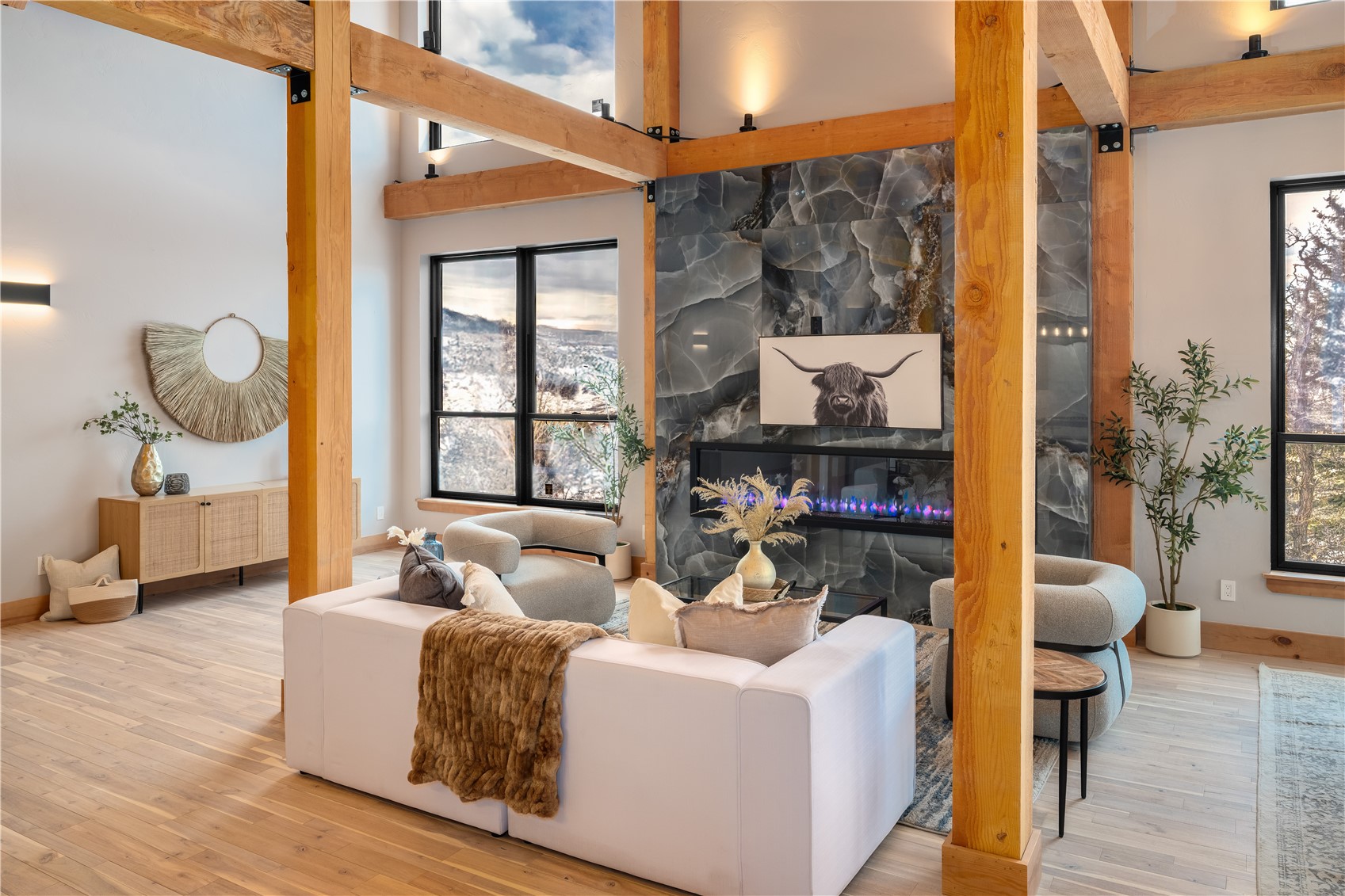 200 Sundance Court, Unit 1 Steamboat Springs, CO 80487 - Photo 6 of 50 Living room featuring hardwood / wood-style floors, a large fireplace, and beamed ceiling