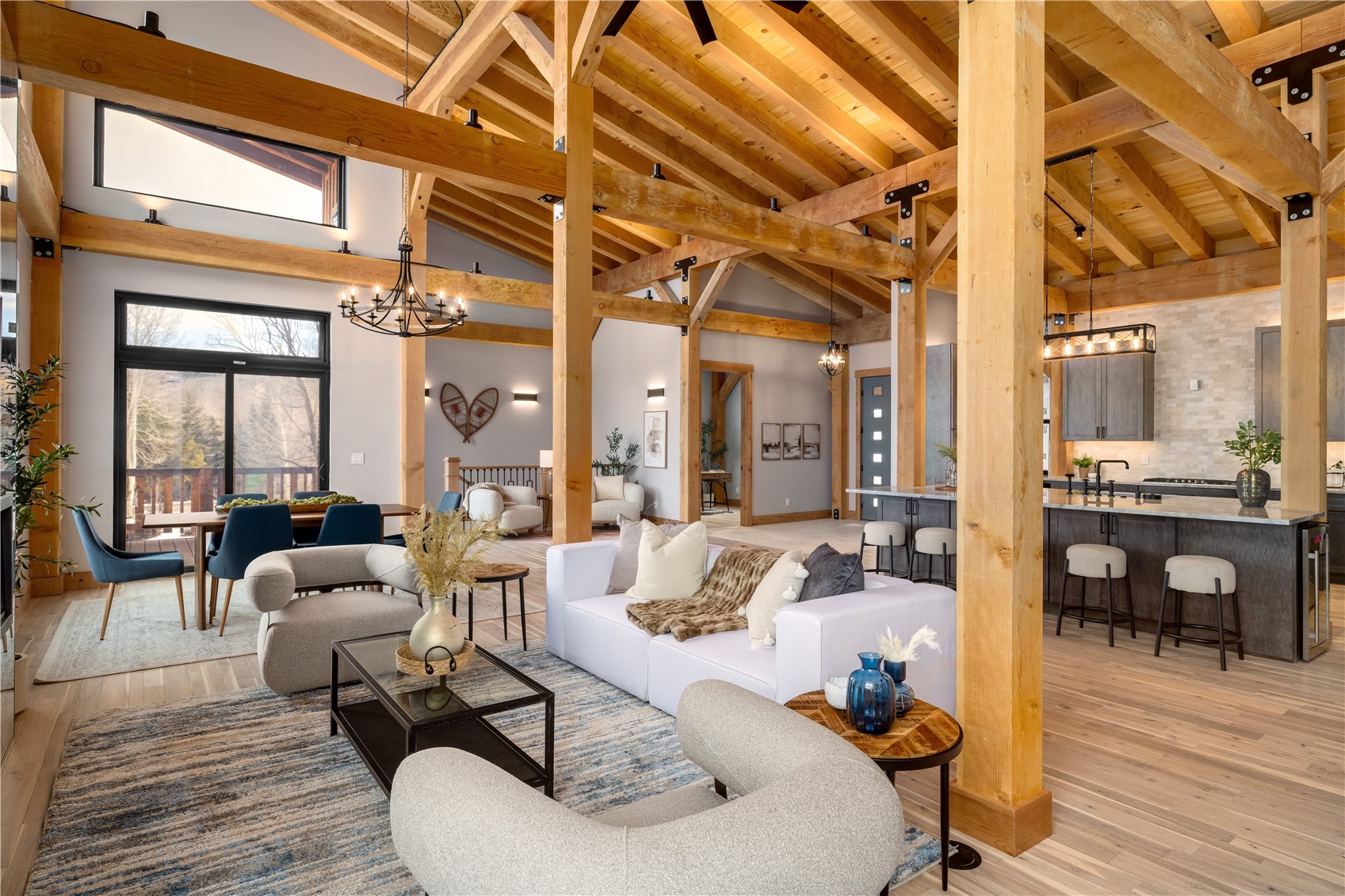 200 Sundance Court, Unit 1 Steamboat Springs, CO 80487 - Photo 8 of 50 Living room with a chandelier, light wood finished floors, high vaulted ceiling, and beamed ceiling
