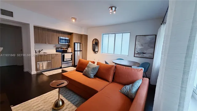 a bedroom with furniture and a wooden floor