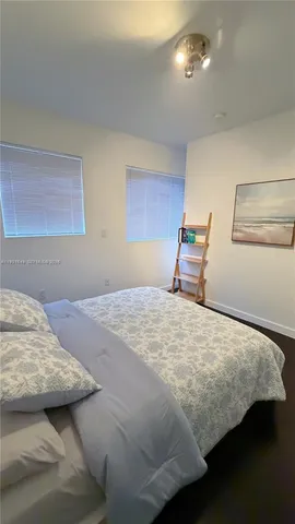 a bedroom with bed and window