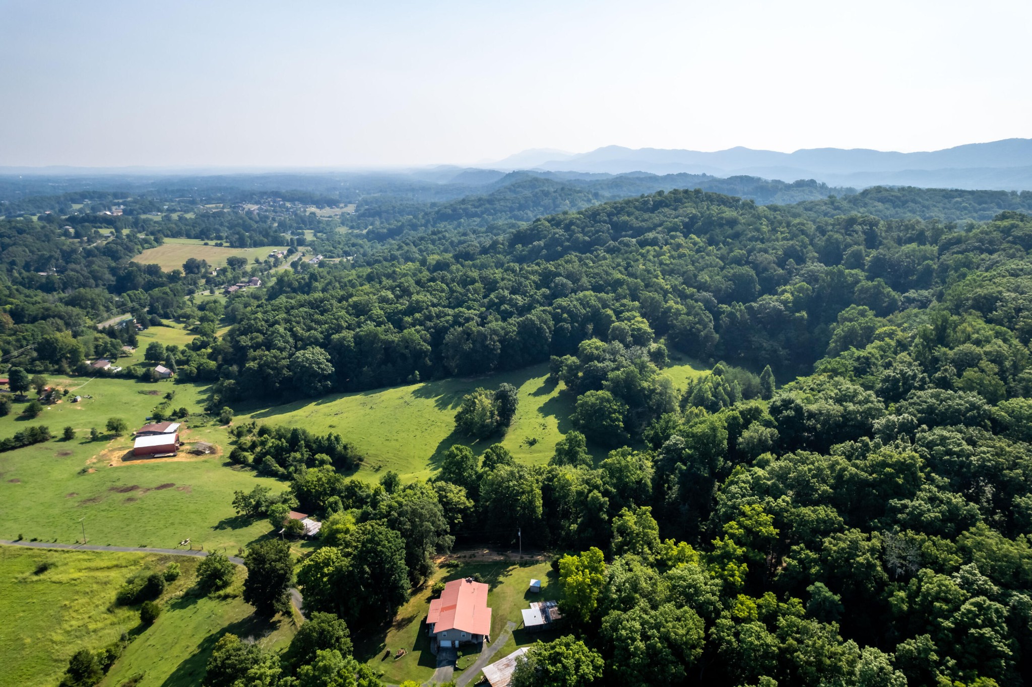 4 Blockhouse Road Maryville, TN 37803 - Photo 11 of 21 an aerial view of green landscape with trees houses and mountain view