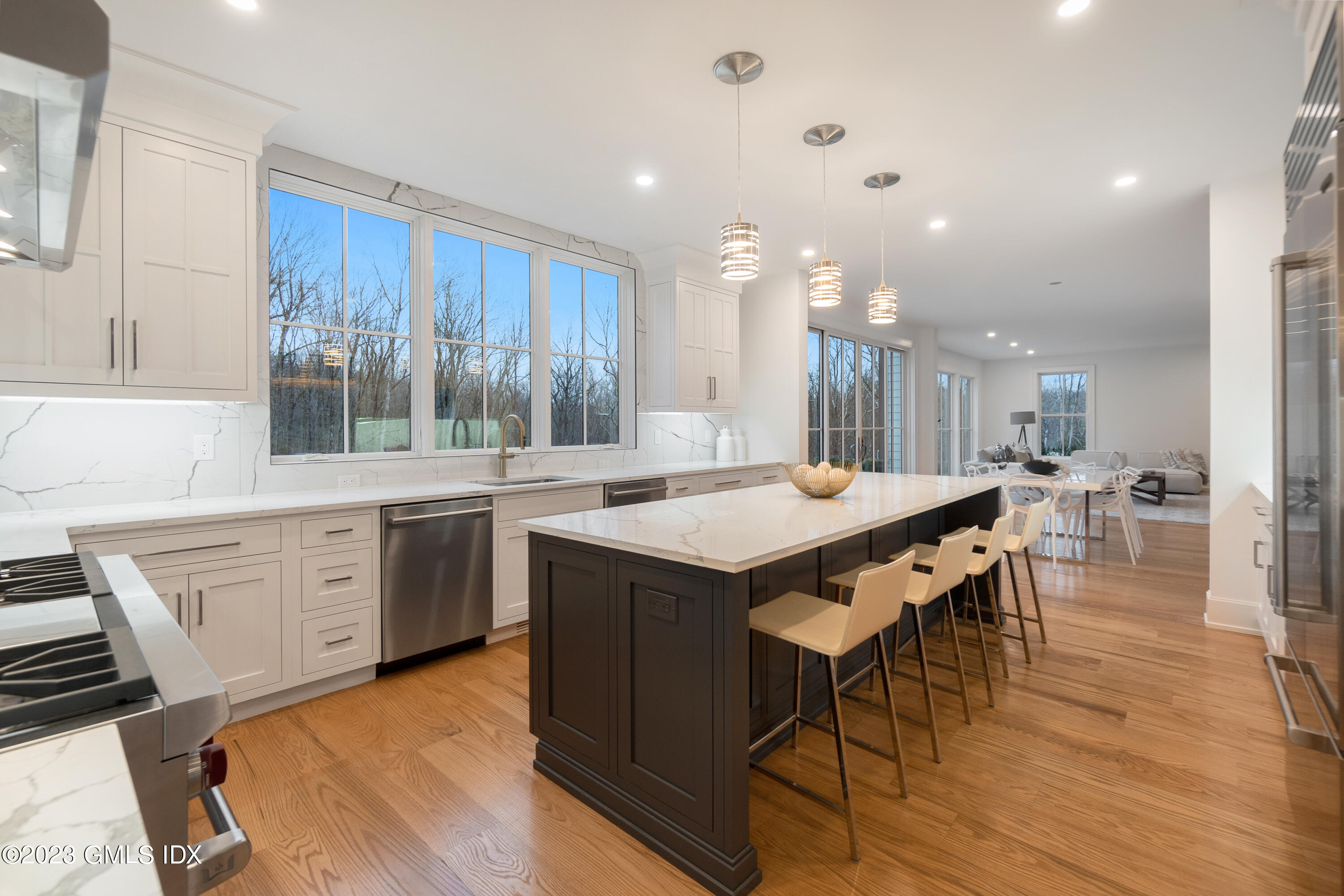 92 Porchuck Road Greenwich, CT 06831 - Photo 5 of 30 a kitchen with a table chairs wooden floors and a view of living room