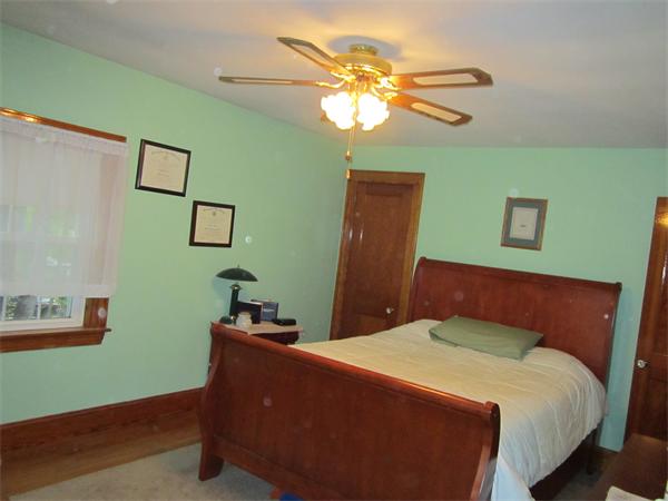 28 Martin Road Douglas, MA 01516 - Photo 17 of 28 a bedroom with a bed and a chandelier