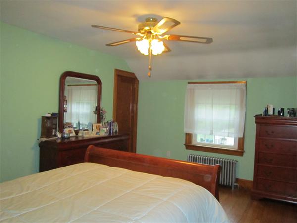 28 Martin Road Douglas, MA 01516 - Photo 18 of 28 a bedroom with a bed and a chandelier