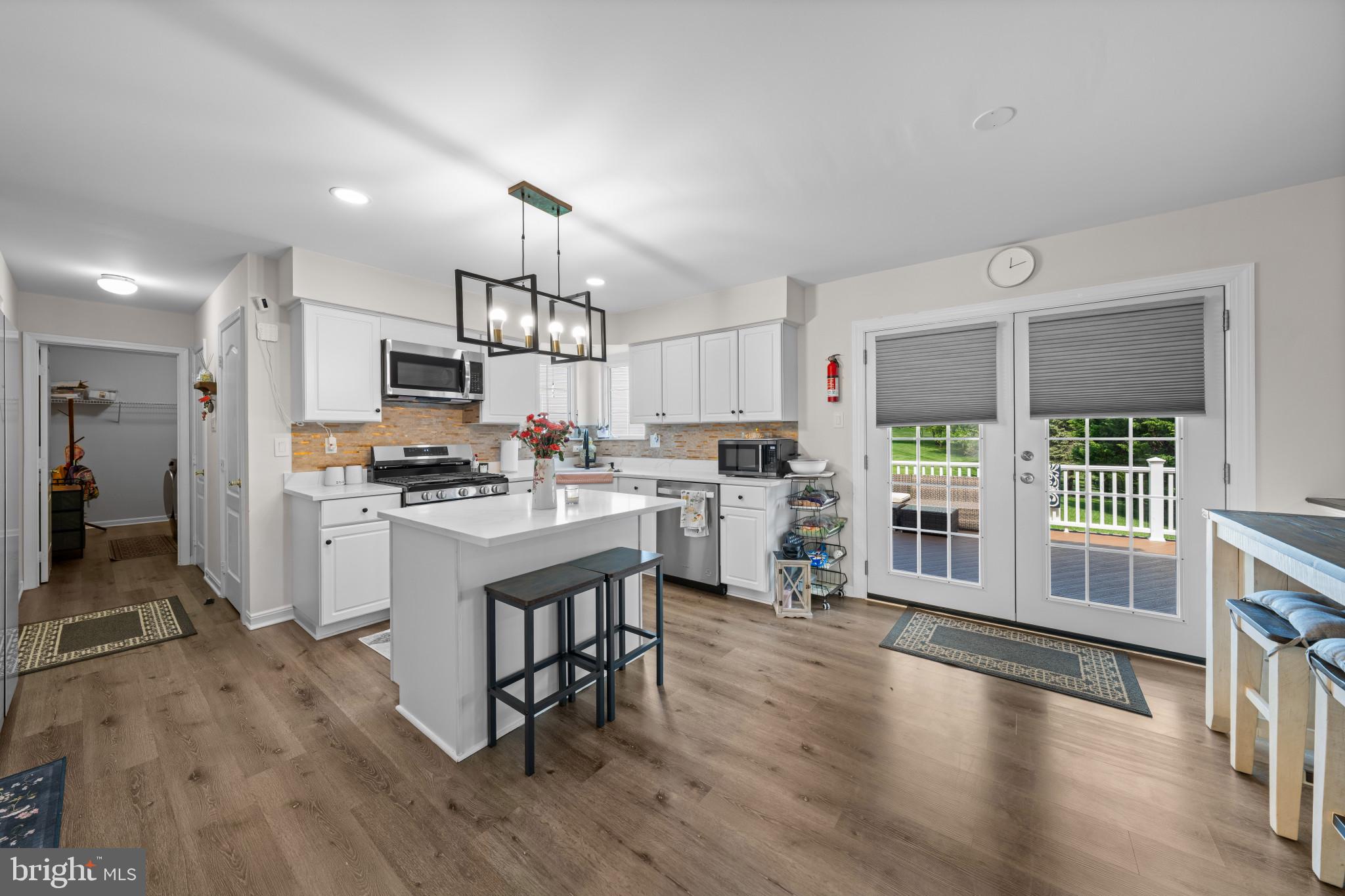4132 Larson Lane Mount Airy, MD 21771 - Photo 12 of 36 a kitchen with white cabinets and stainless steel appliances