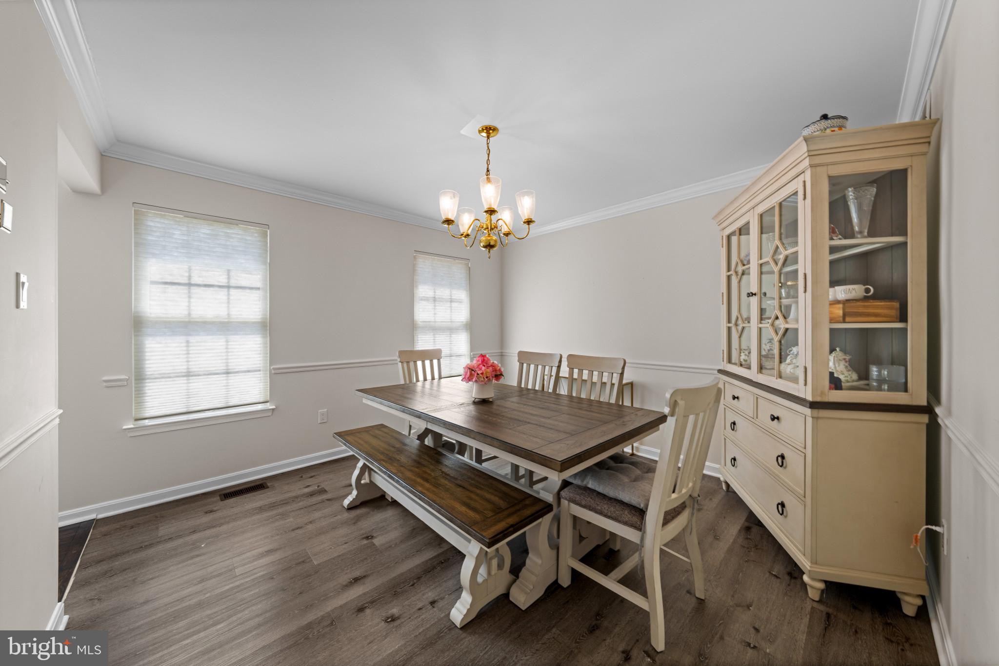 4132 Larson Lane Mount Airy, MD 21771 - Photo 14 of 36 a dining room with wooden floor a chandelier a wooden table and chairs