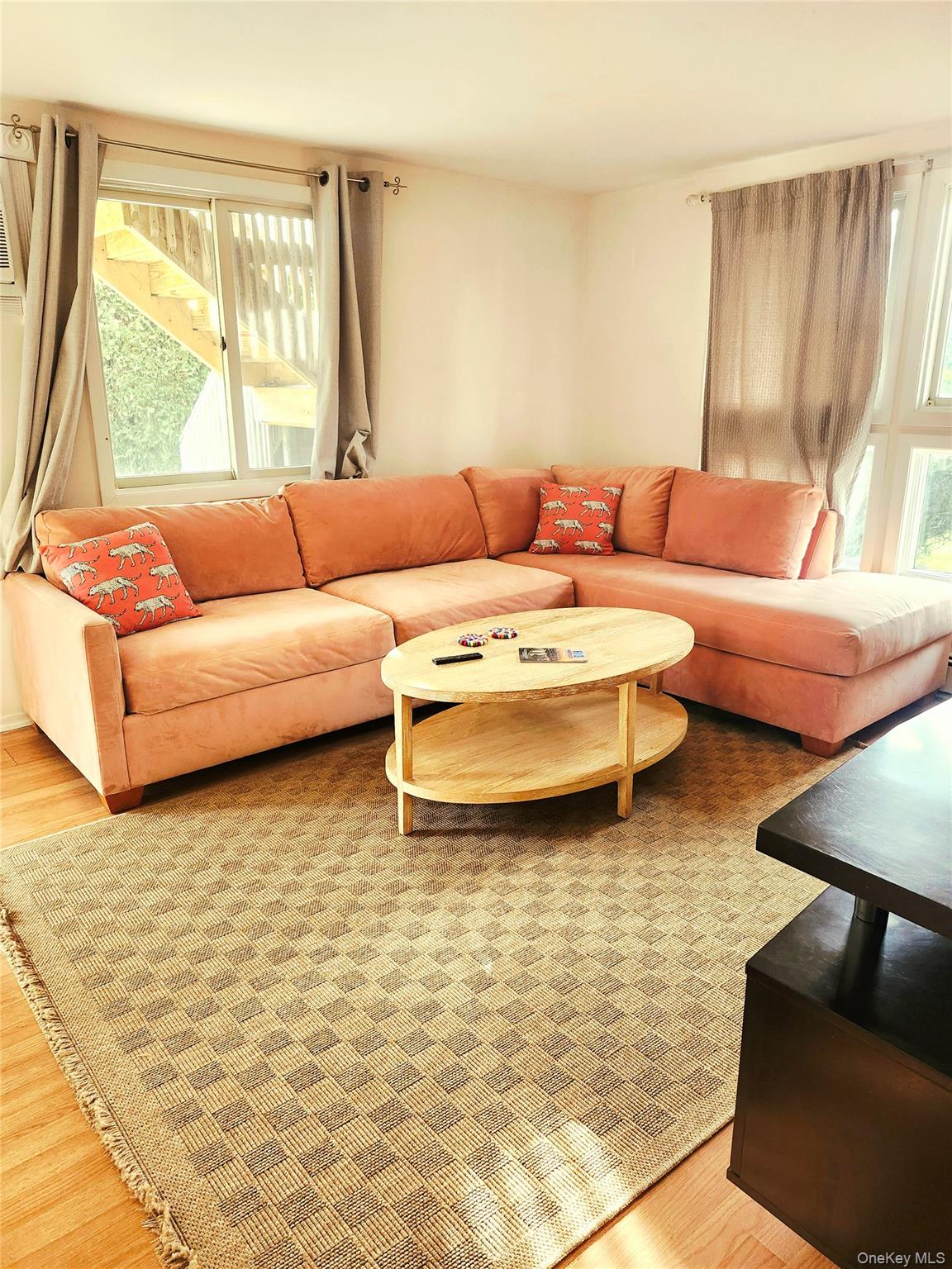 95 Springville Road South, Unit 3 Hampton Bays, NY 11946 - Photo 17 of 17 a living room with furniture and a large window