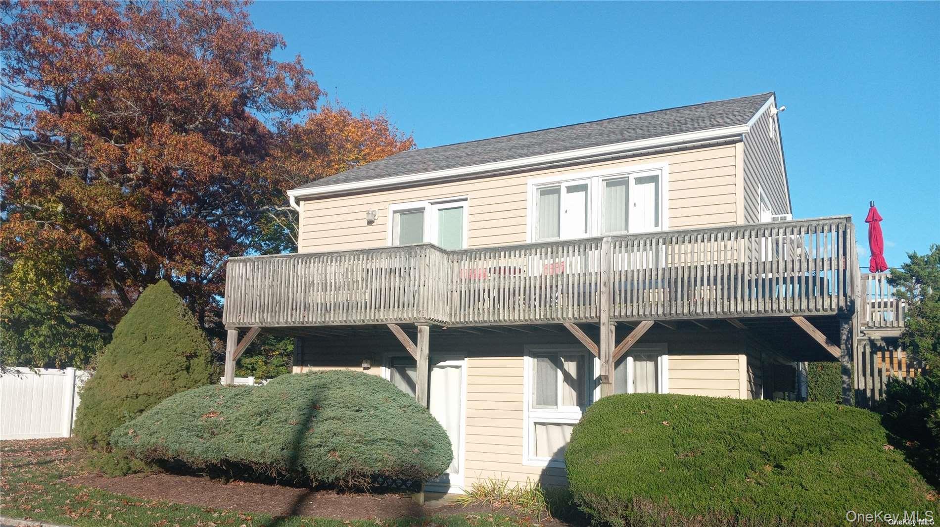 95 Springville Road South, Unit 3 Hampton Bays, NY 11946 - Photo 2 of 17 a front view of a house with balcony