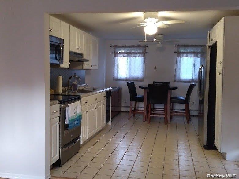 95 Springville Road South, Unit 3 Hampton Bays, NY 11946 - Photo 4 of 17 a kitchen with a sink and cabinets