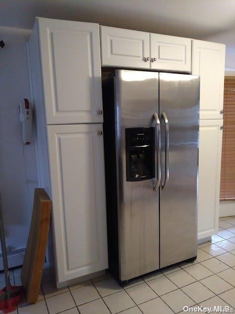 95 Springville Road South, Unit 3 Hampton Bays, NY 11946 - Photo 7 of 17 a metallic refrigerator freezer sitting in a kitchen