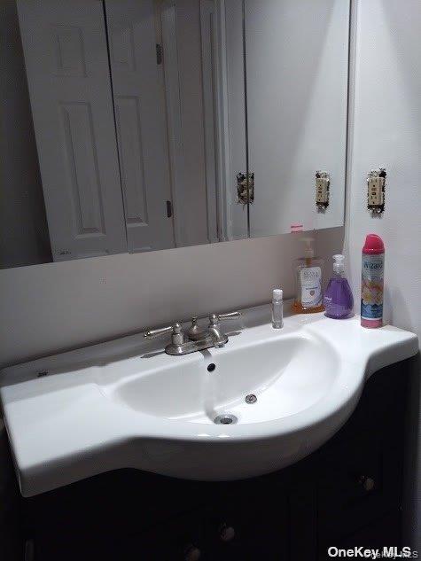 95 Springville Road South, Unit 3 Hampton Bays, NY 11946 - Photo 9 of 17 a bathroom with a sink and a mirror