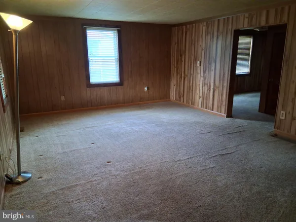 an empty room with windows and closet