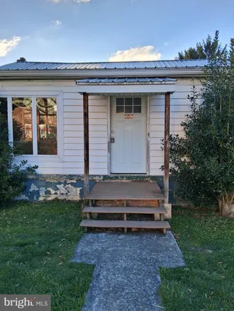 a view of a house with a yard and sitting area