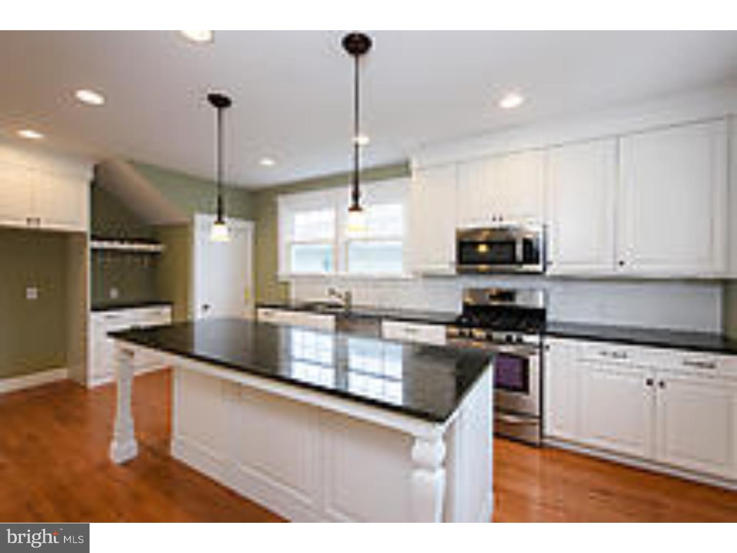 131 South Rolling Road Springfield, PA 19064 - Photo 11 of 25 a kitchen with stainless steel appliances kitchen island granite countertop a sink a stove and cabinets