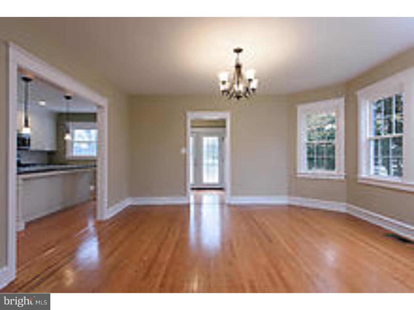 131 South Rolling Road Springfield, PA 19064 - Photo 6 of 25 a view of empty room with wooden floor and kitchen view