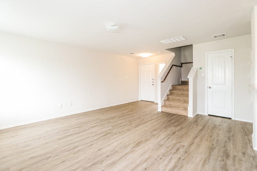 3765 Alexus Drive Conroe, TX 77301 - Photo 8 of 19 a view of an empty room with wooden floor and stairs