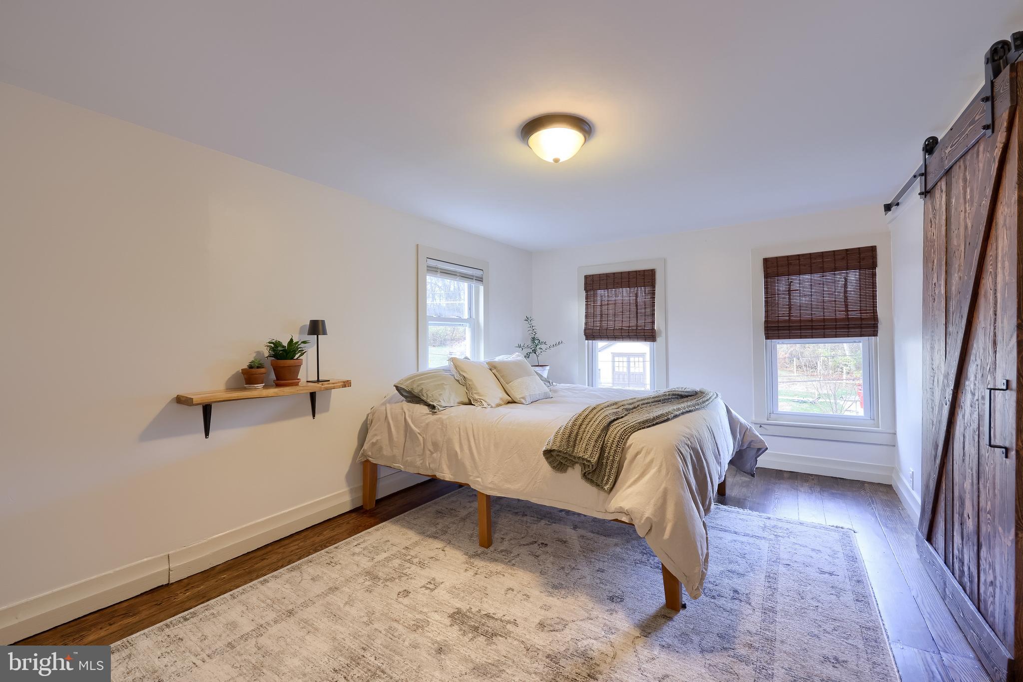 770 Mohns Hill Road Reading, PA 19608 - Photo 32 of 53 a spacious bedroom with a bed and wooden floor