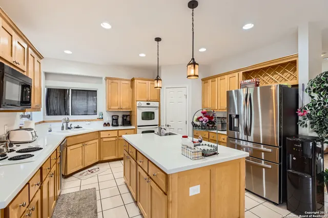 a kitchen with a table chairs and white appliances