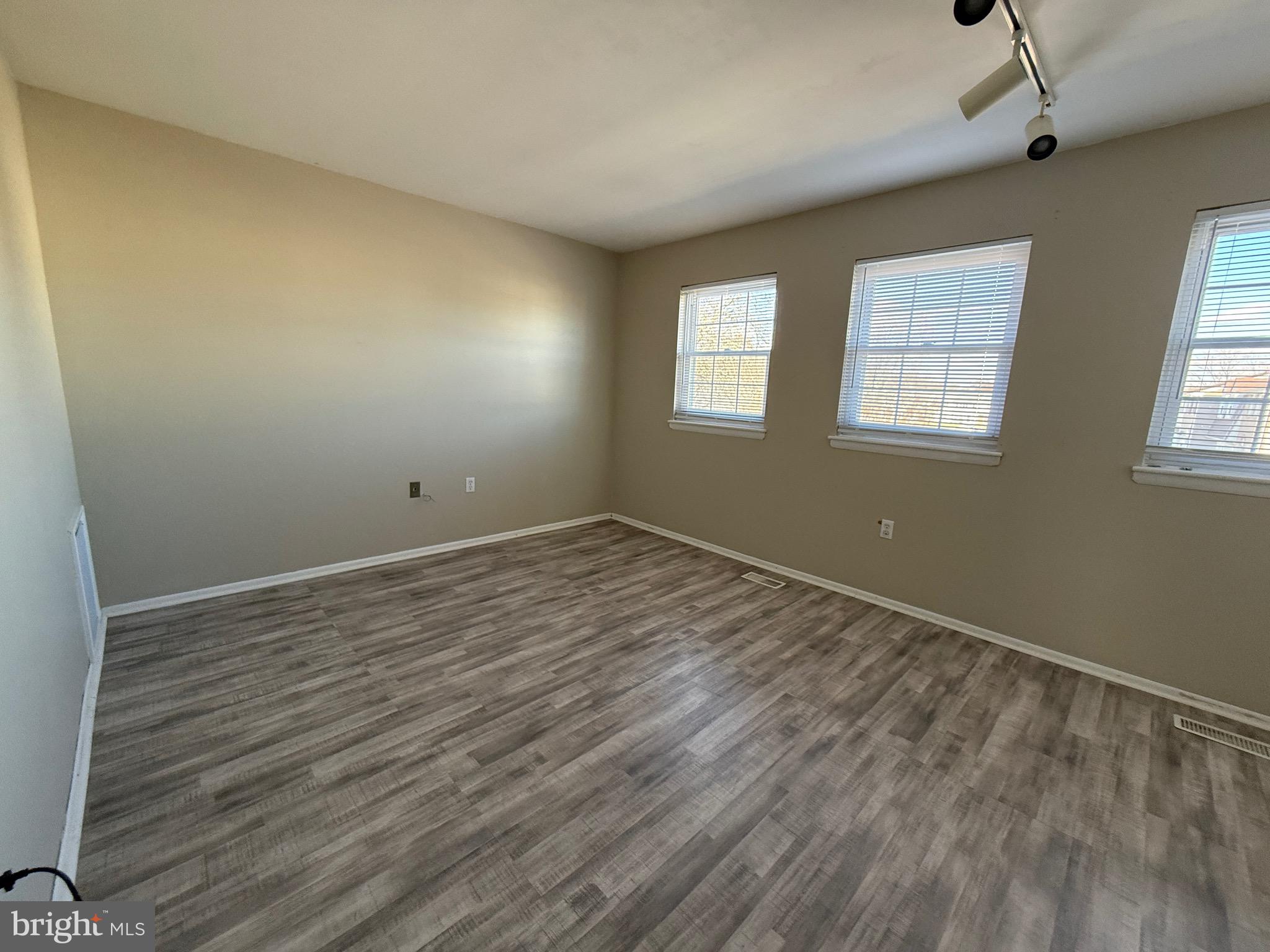 34 King Charles Circle, Unit 34 Rosedale, MD 21237 - Photo 14 of 25 a view of empty room with wooden floor and fan