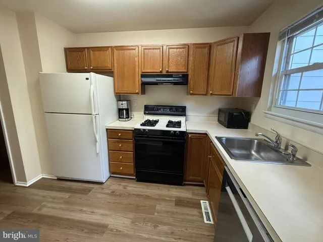 a kitchen with a refrigerator and a sink