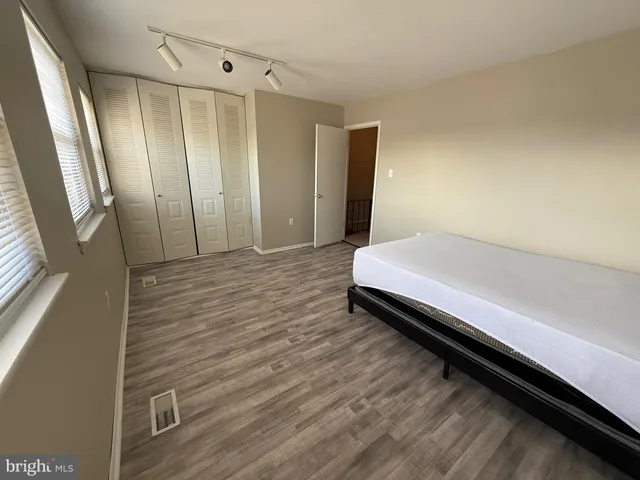 a view of a room with wooden floor and window