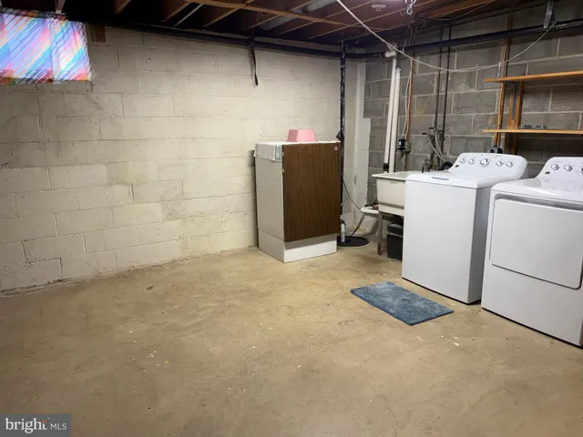 a view of empty room with wooden walls