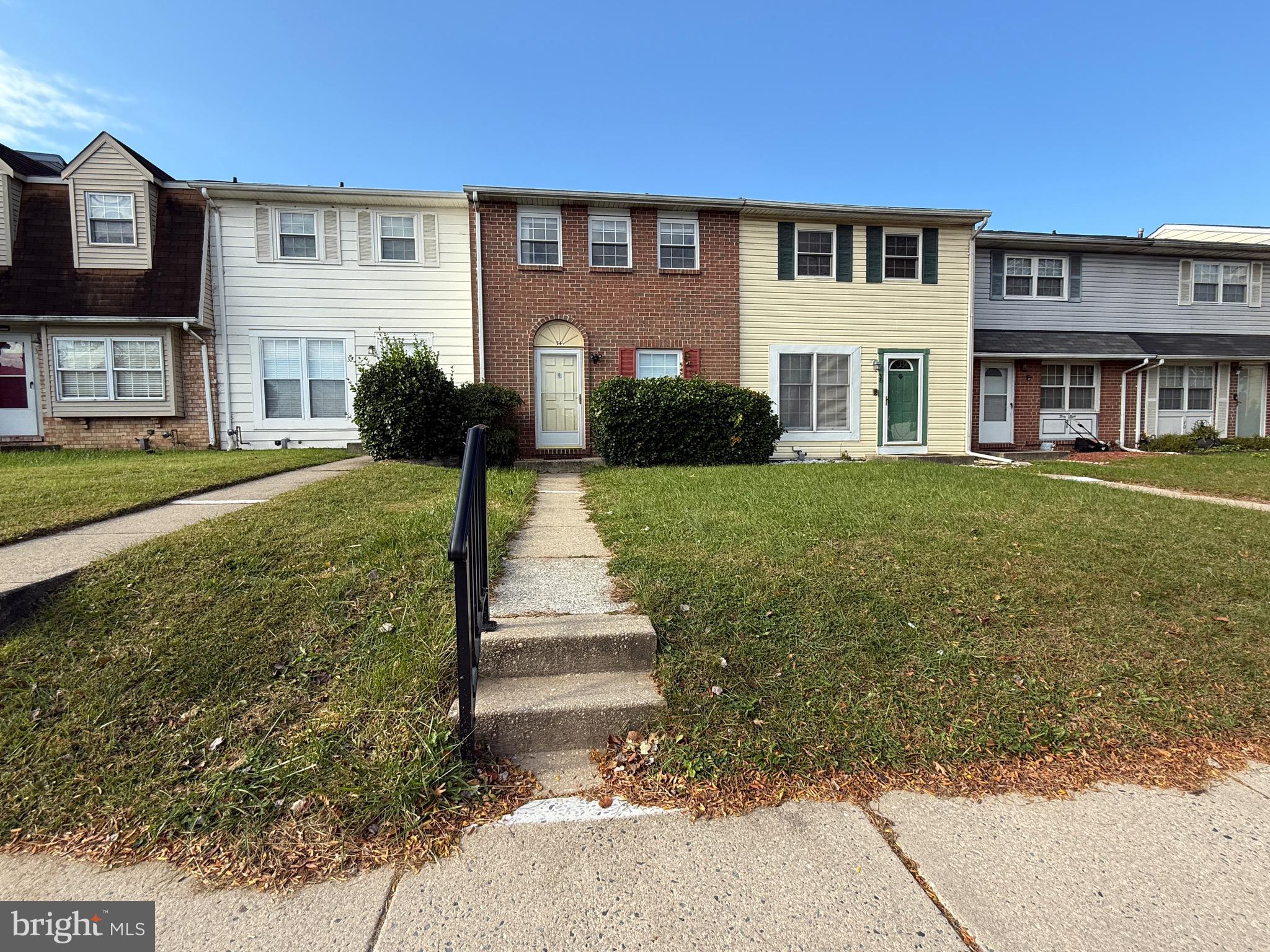 34 King Charles Circle, Unit 34 Rosedale, MD 21237 - Photo 2 of 25 a front view of a house with a yard