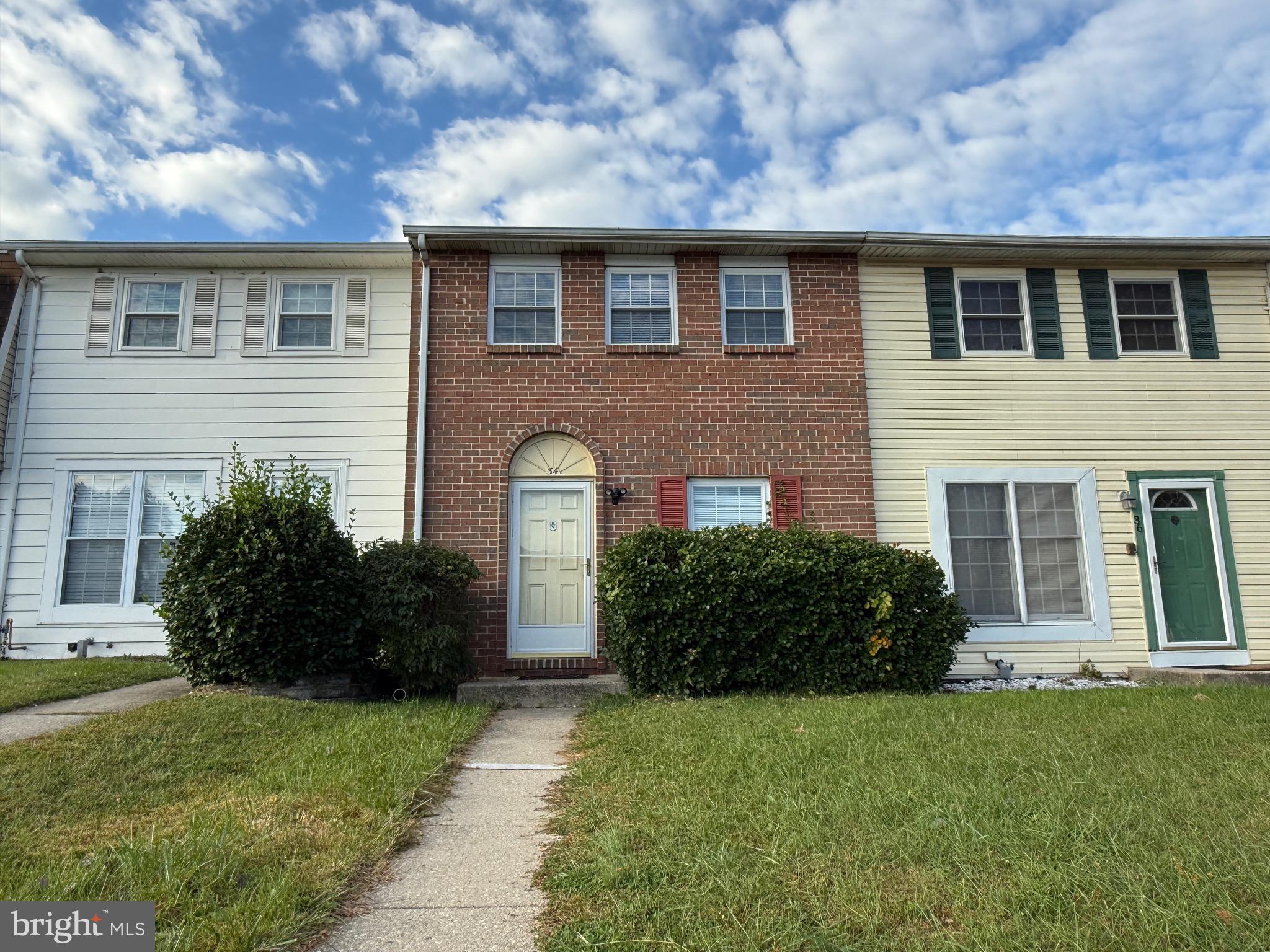 34 King Charles Circle, Unit 34 Rosedale, MD 21237 - Photo 3 of 25 a front view of a house with a garden