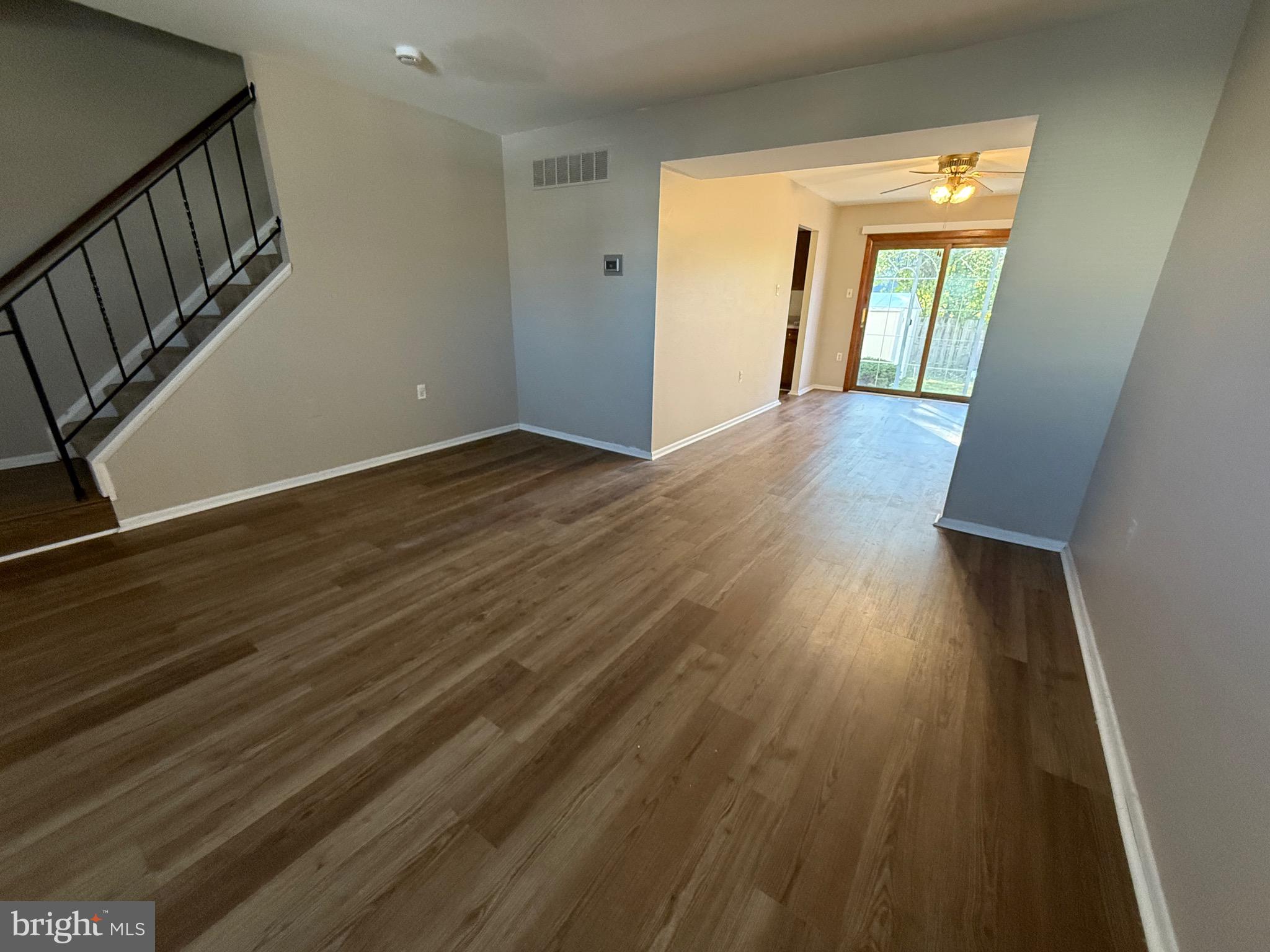 34 King Charles Circle, Unit 34 Rosedale, MD 21237 - Photo 5 of 25 a view of an empty room with wooden floor and a window