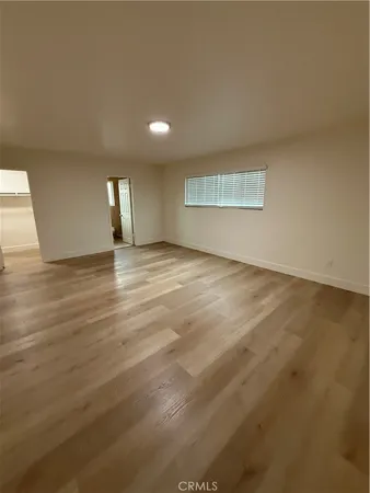 a view of a room with wooden floor