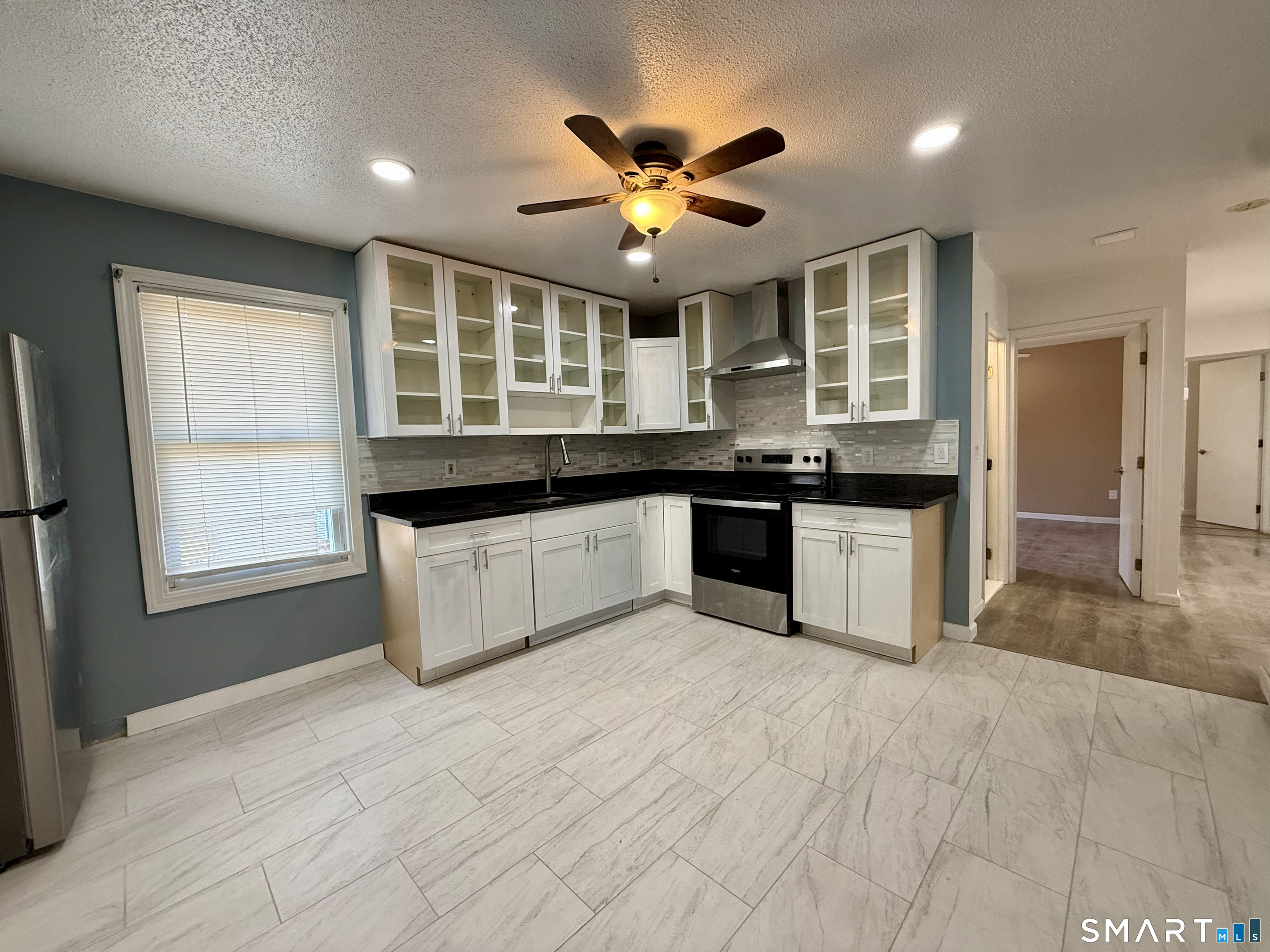 8 Scott Street, Unit 2 Naugatuck, CT 06770 - Photo 1 of 15 a large kitchen with stainless steel appliances granite countertop a sink and cabinets