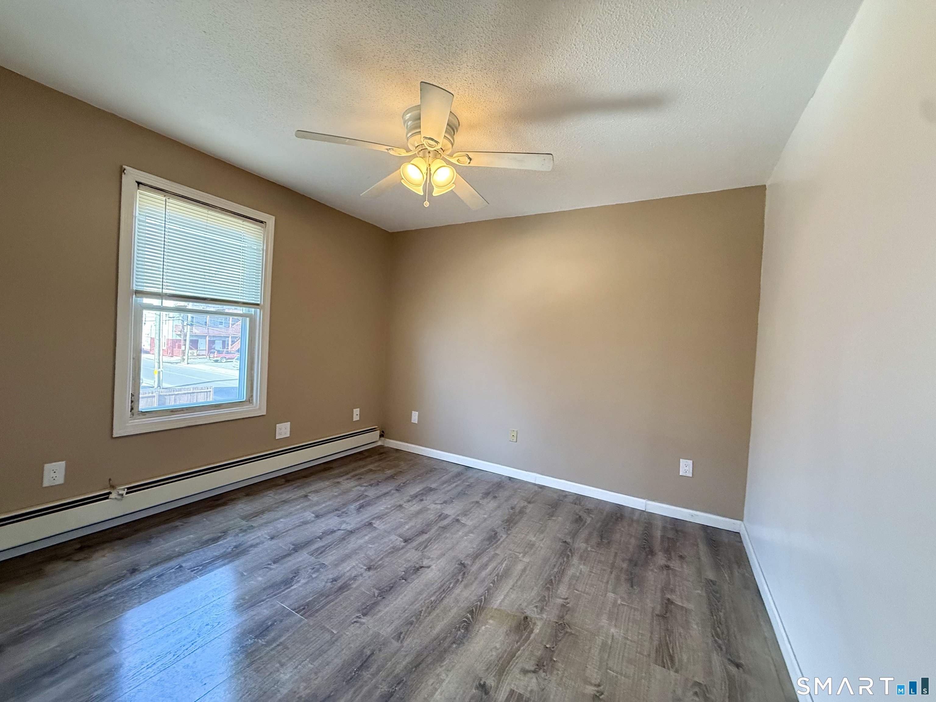 8 Scott Street, Unit 2 Naugatuck, CT 06770 - Photo 7 of 15 an empty room with wooden floor fan and windows