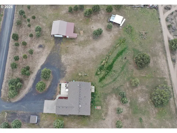 an aerial view of a house with a yard