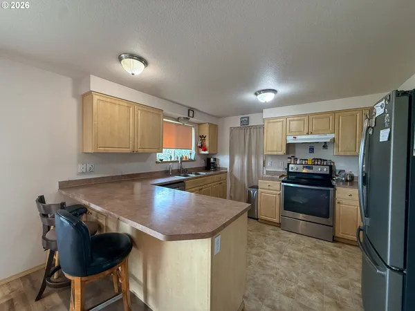 a kitchen with kitchen island a counter space a sink and appliances