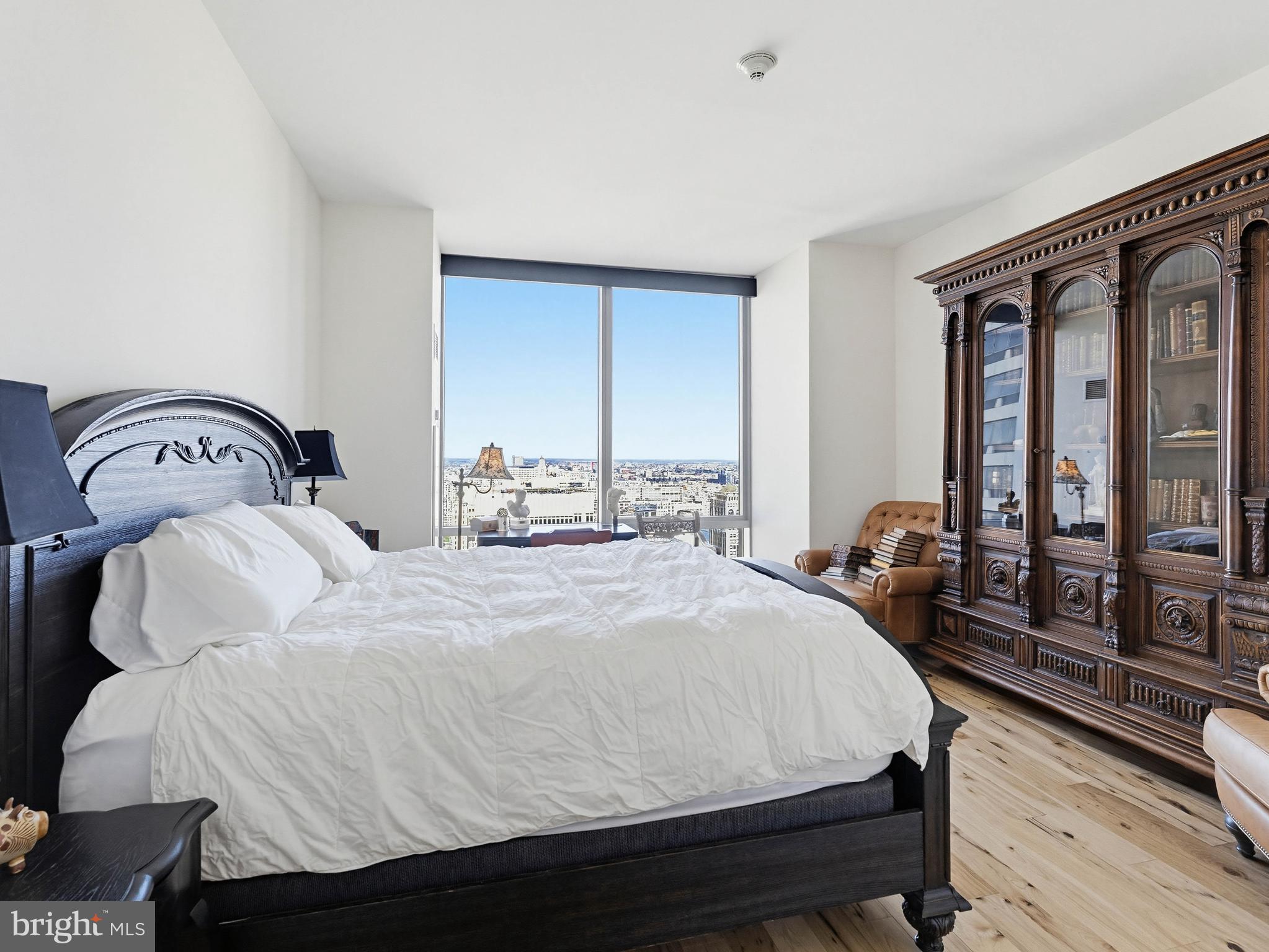 1414 South Penn Square, Unit 32F Philadelphia, PA 19102 - Photo 11 of 35 a bedroom with a bed and wooden floor