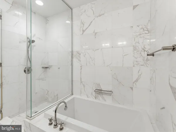 a bathroom with a bathtub and a shower