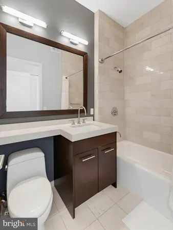 a bathroom with a sink vanity mirror and toilet