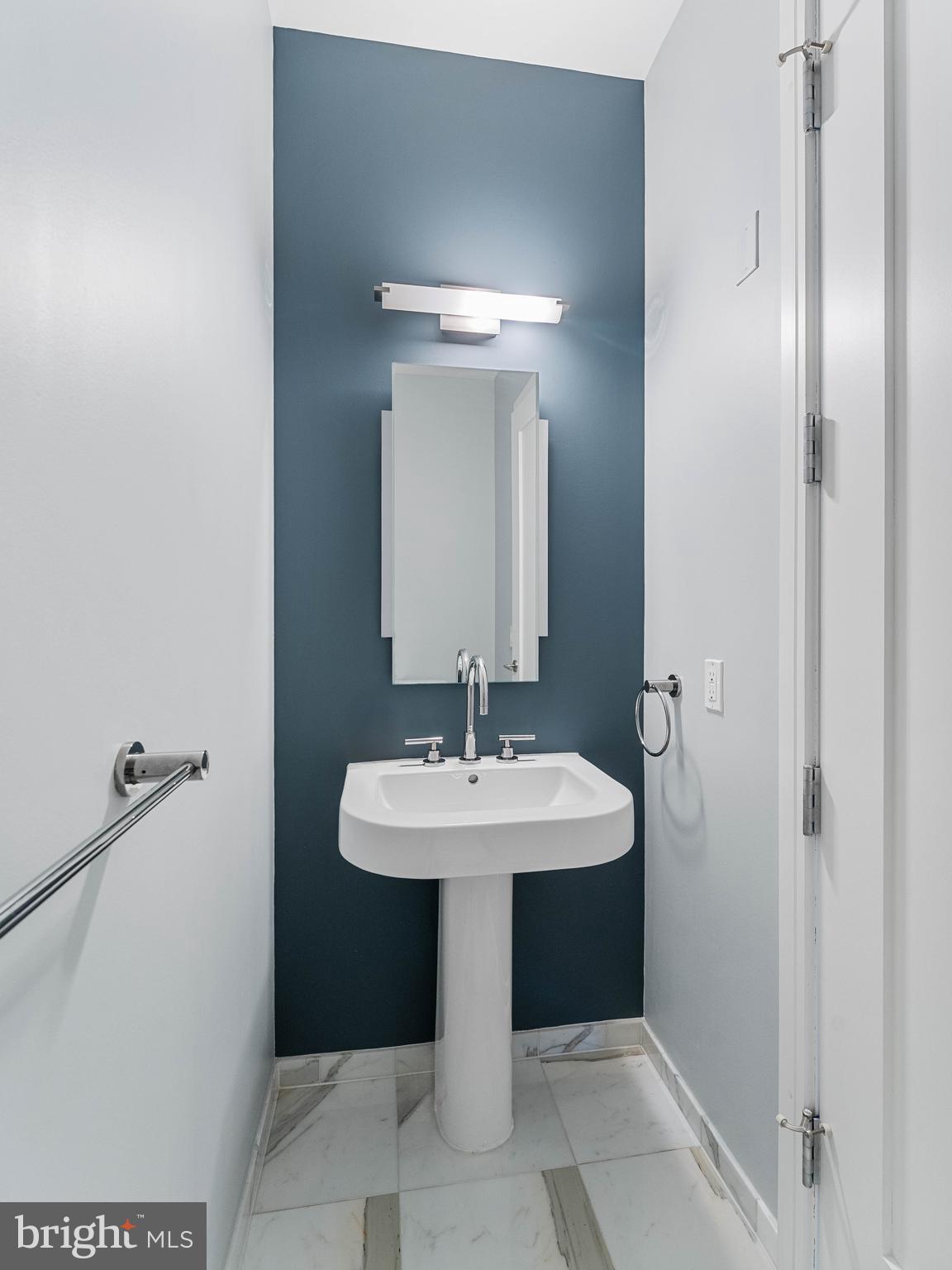 1414 South Penn Square, Unit 32F Philadelphia, PA 19102 - Photo 21 of 35 a bathroom with a sink and a mirror