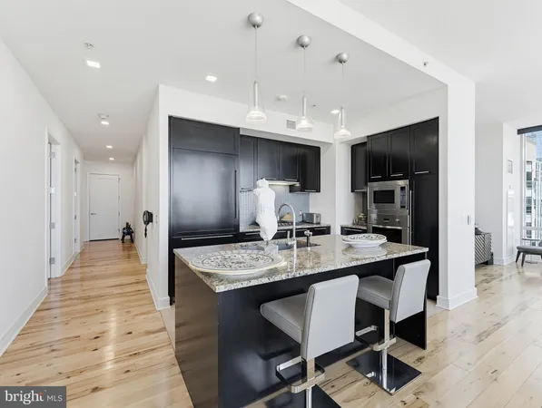 a large kitchen with a table and chairs in it