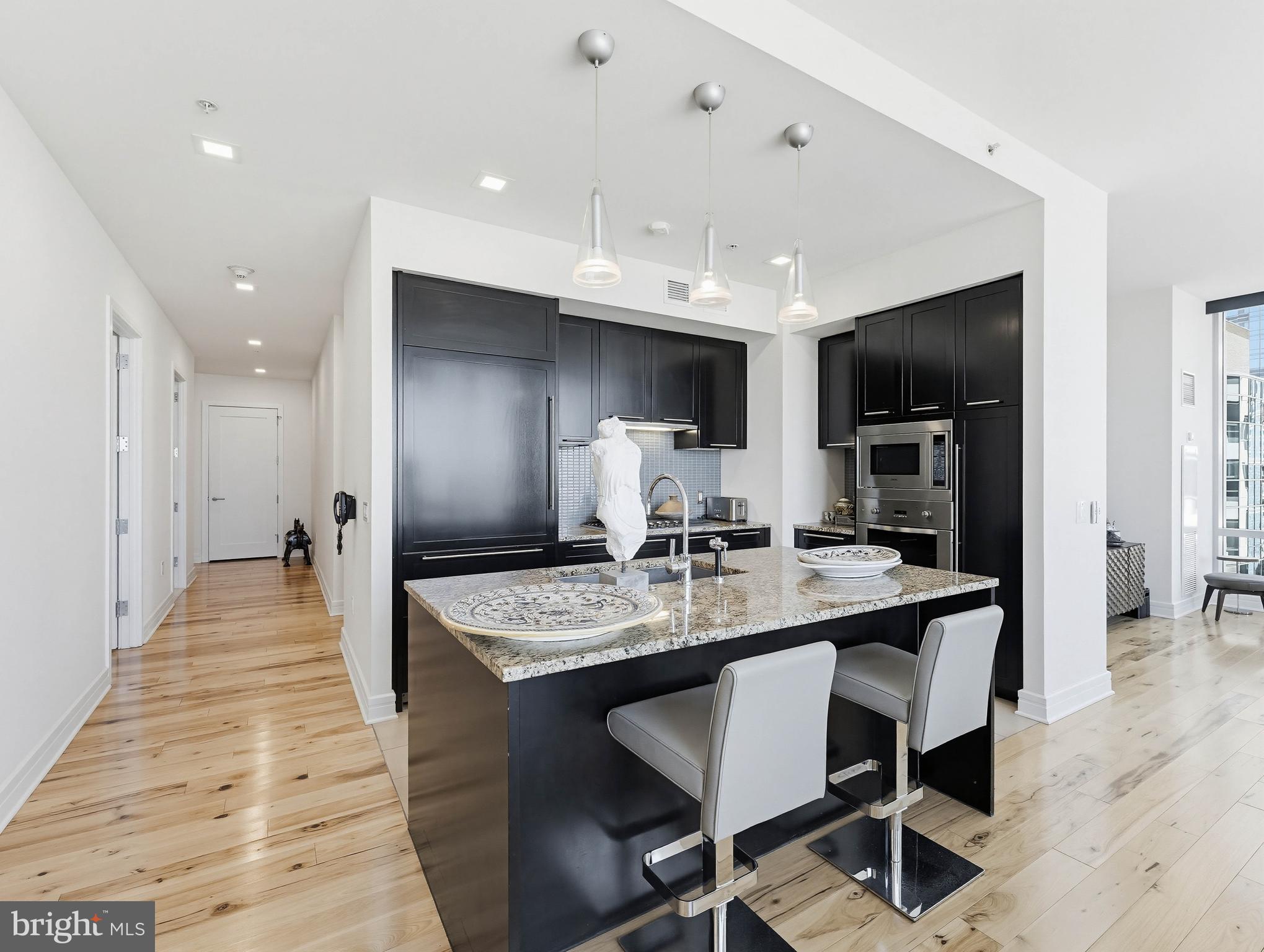 1414 South Penn Square, Unit 32F Philadelphia, PA 19102 - Photo 8 of 35 a large kitchen with a table and chairs in it