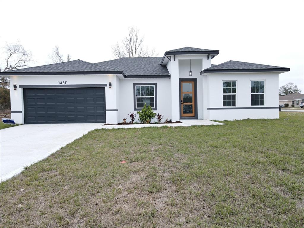 a front view of a house with a yard and garage