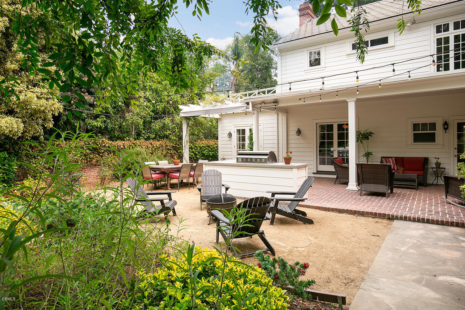 1041 Prospect Boulevard Pasadena, CA 91103 - Photo 46 of 47 a view of a patio with table and chairs potted plants and large tree